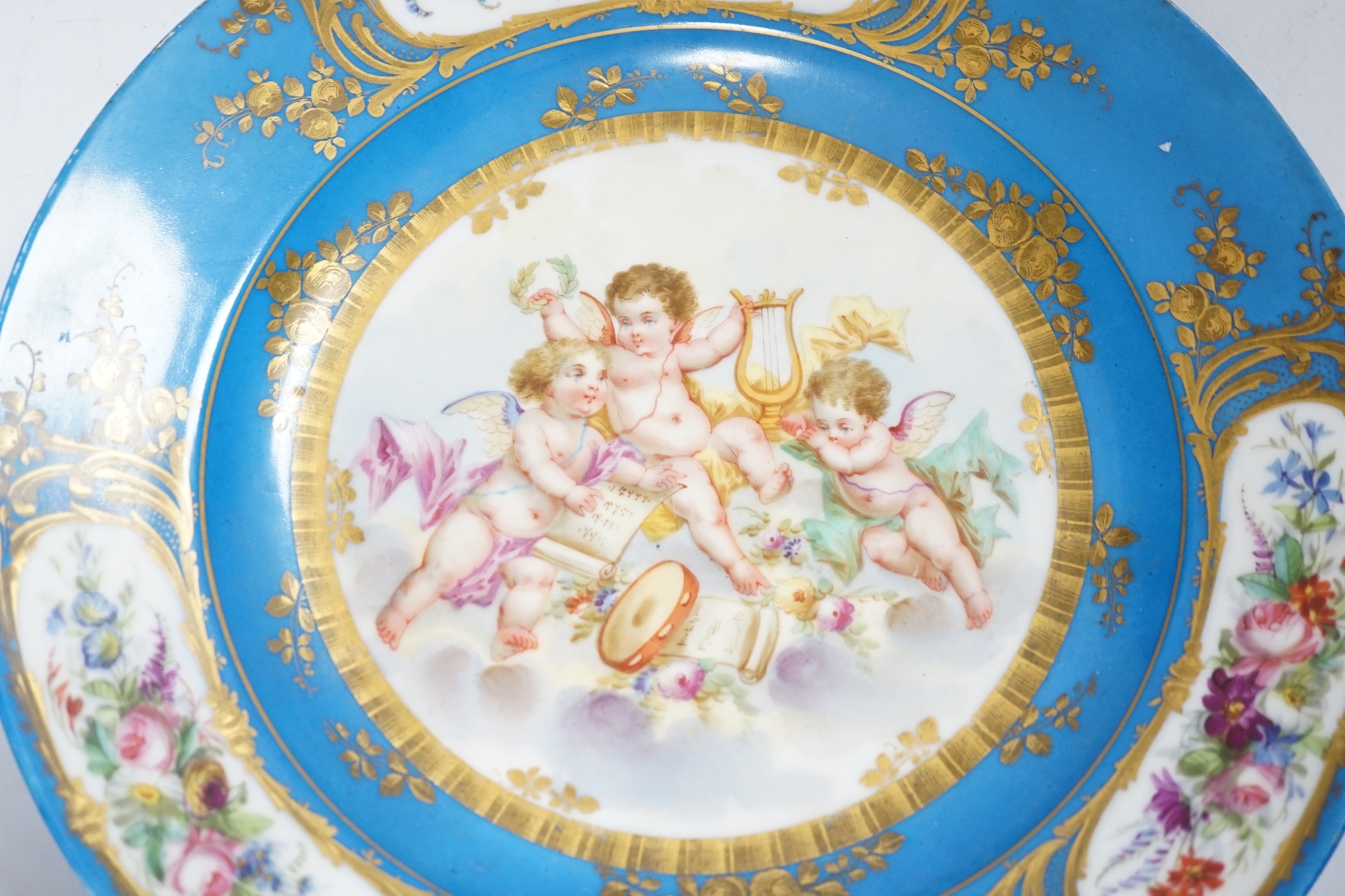A Sevres style dish decorated with amorini, 33cm